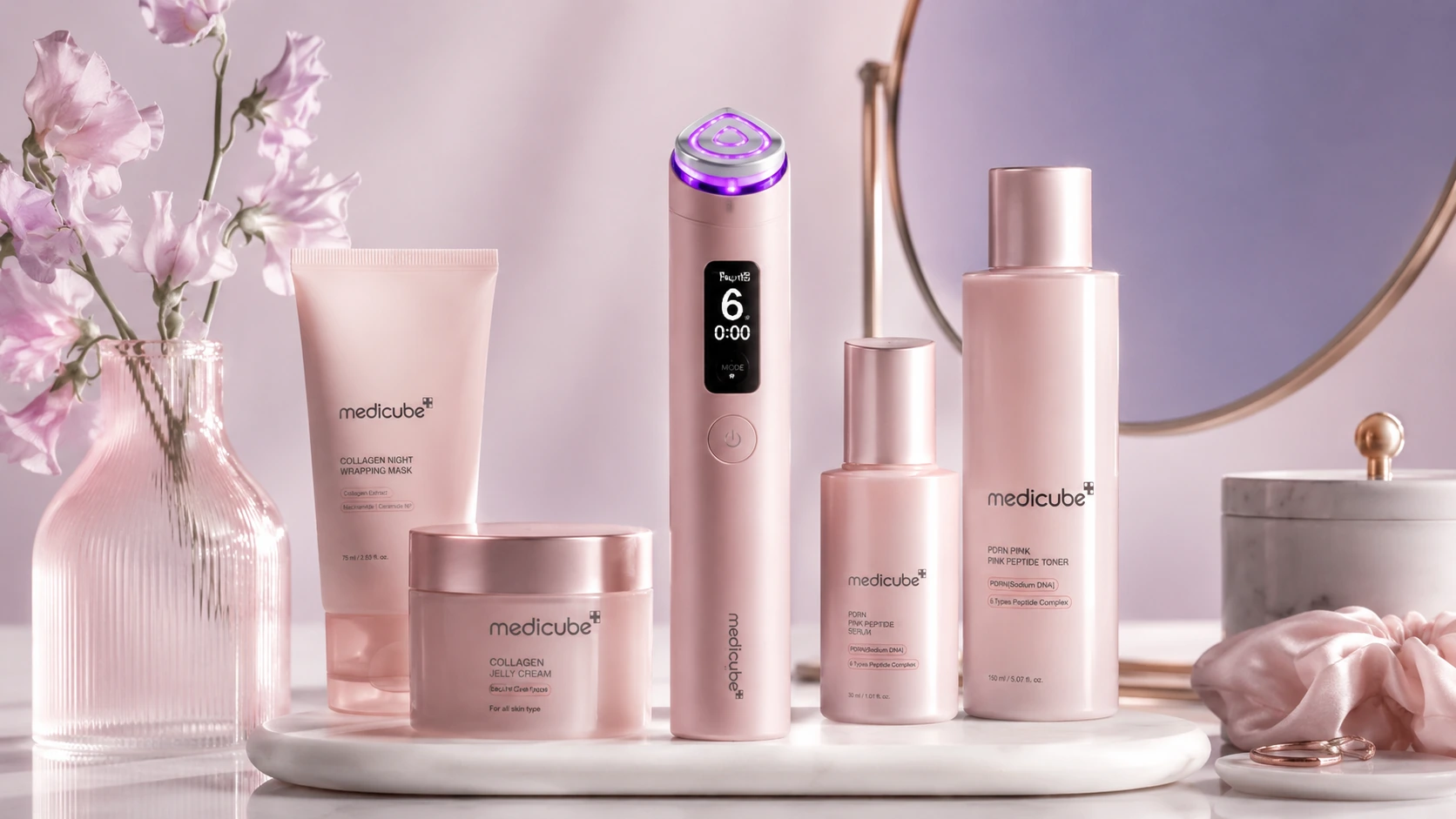 Medicube skincare and device collection arranged on a soft pink vanity