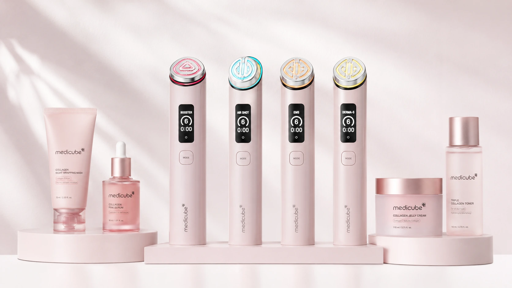 Medicube device lineup with skincare products in a pale pink studio setting